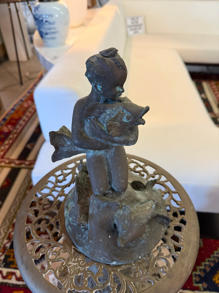 Sculpture of boy with fish