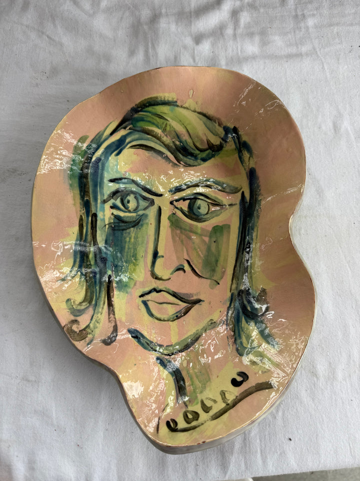 Face pottery plate signed