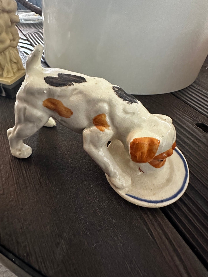 Dog drinking sculpture