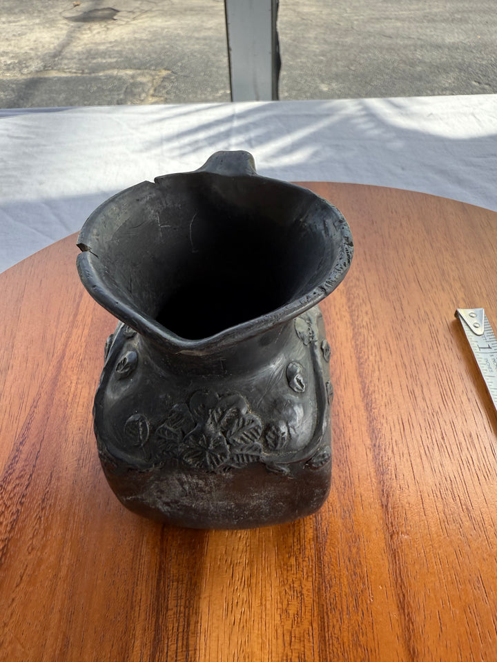 Handmade small pitcher has chips